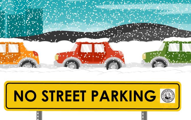 cars parked in snow on curb with no street parking sign